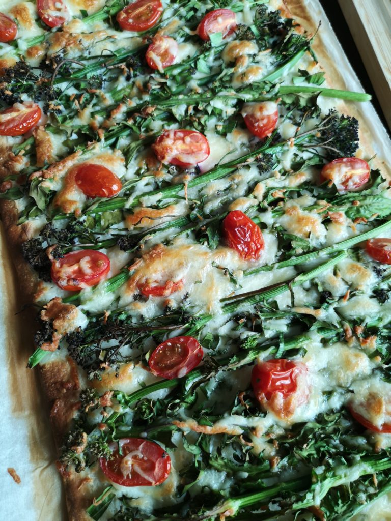 Pizza topped with sprouting broccoli